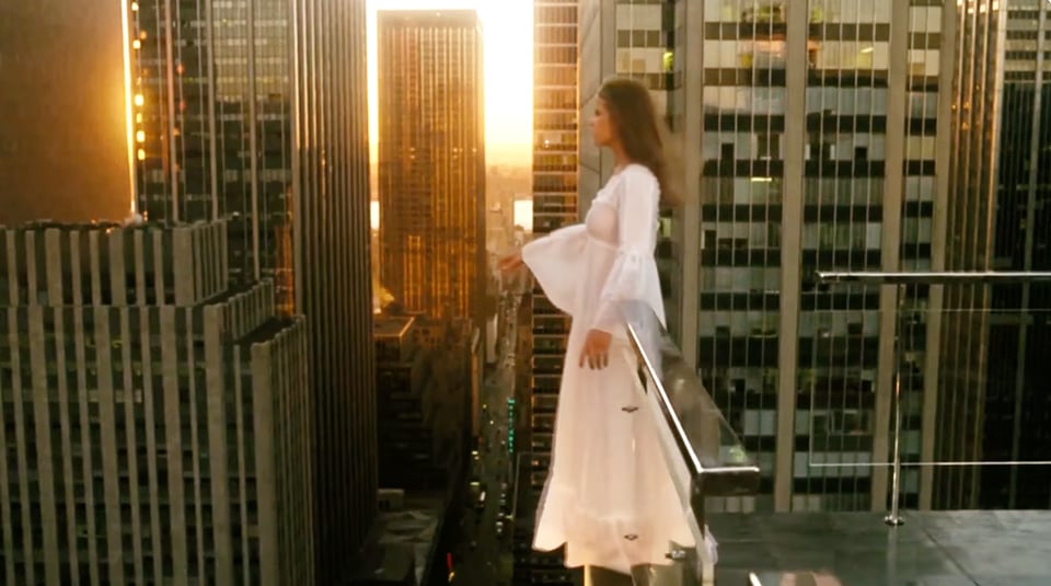 Linda Blair as Regan MacNeil, teetering dangerously on an urban rooftop in a flowing white dress in Exorcist II: The Heretic