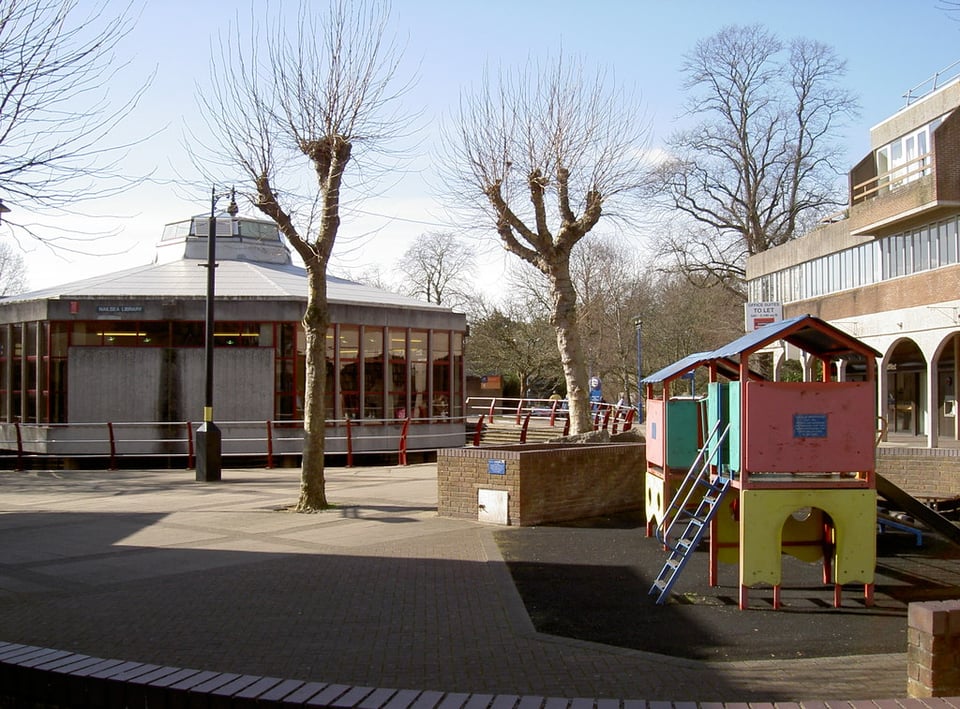The library from another angle in the early 2000s. A rather sun faded children's climbing frame is in the foreground and some railings have been added.