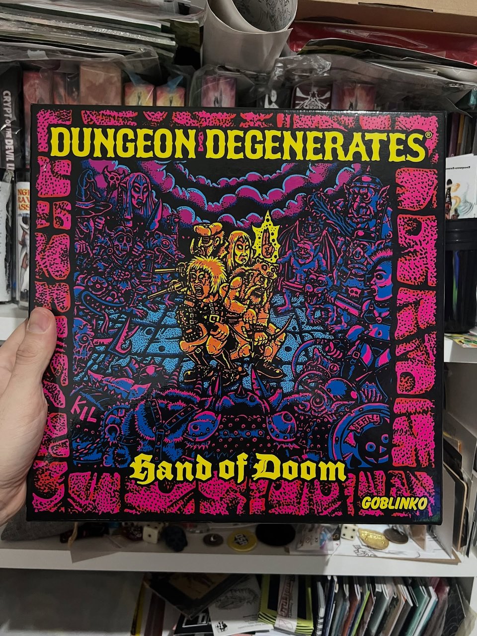 Very underground like artwork of adventurers surrounded by monsters with psychedelic colorts. Box title: Dungeon Degenerates