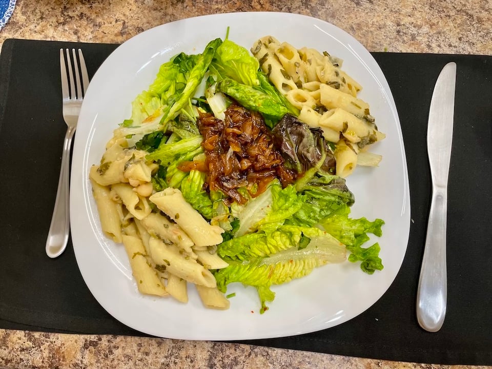 A plate of pasta and salad