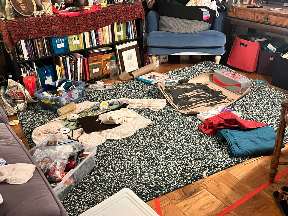 A messy living room lovingly filled with the work of a night.