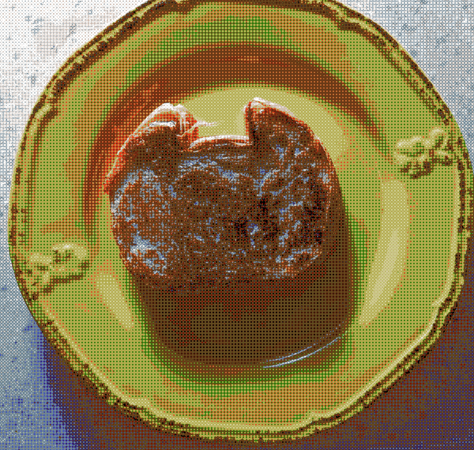 A grilled cheese sandwich made with cat-shaped bread on a small yellow plate.