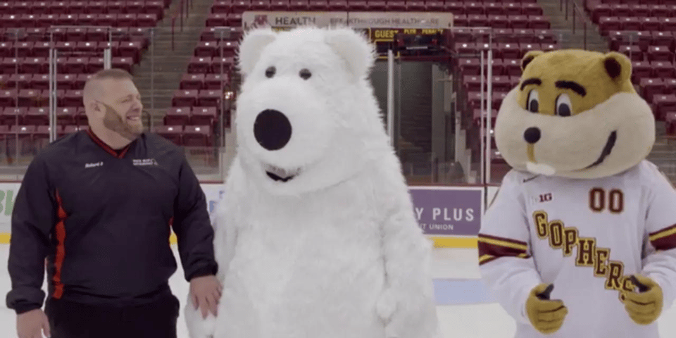A man, a polar bear mascot and some sort of chipmunk.