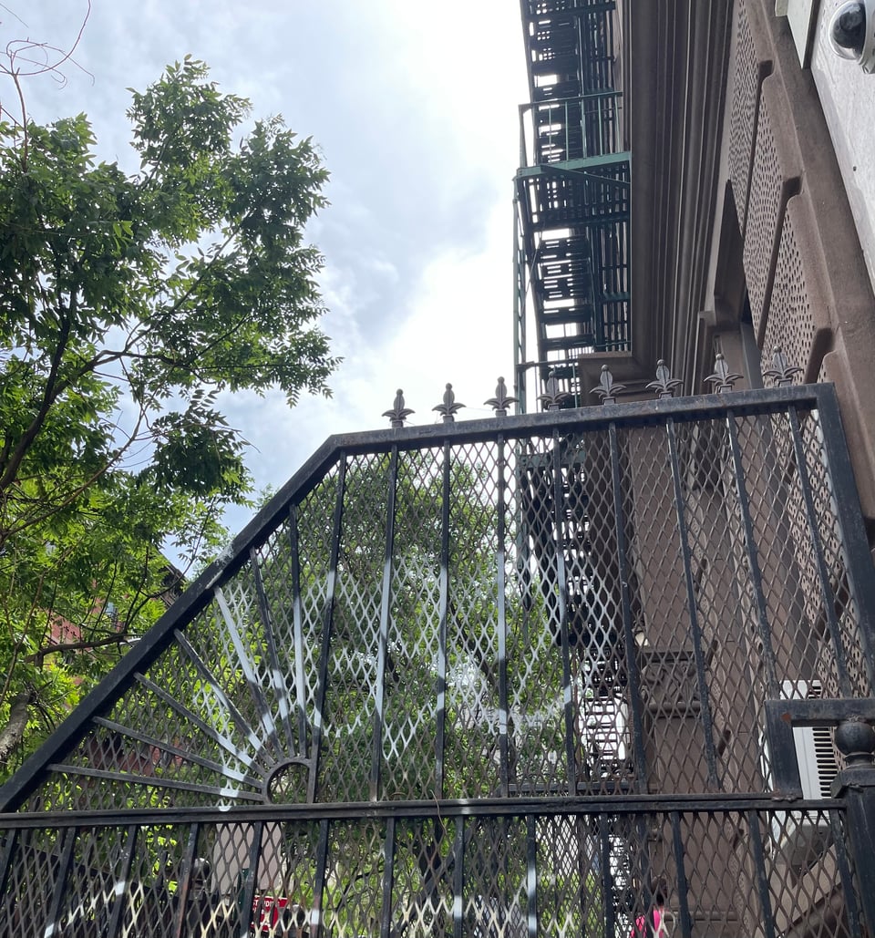 A cast iron fence with graffiti