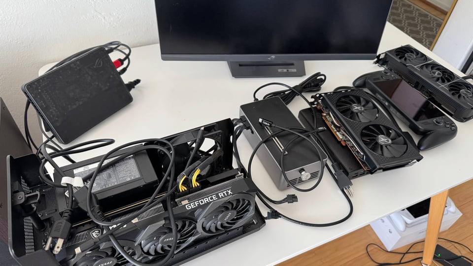 table with multiple graphics cards and a computer monitor