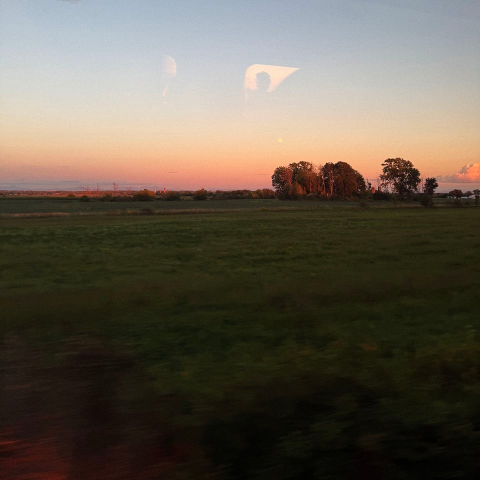 a very nice sunset seen from the speeding window of a train