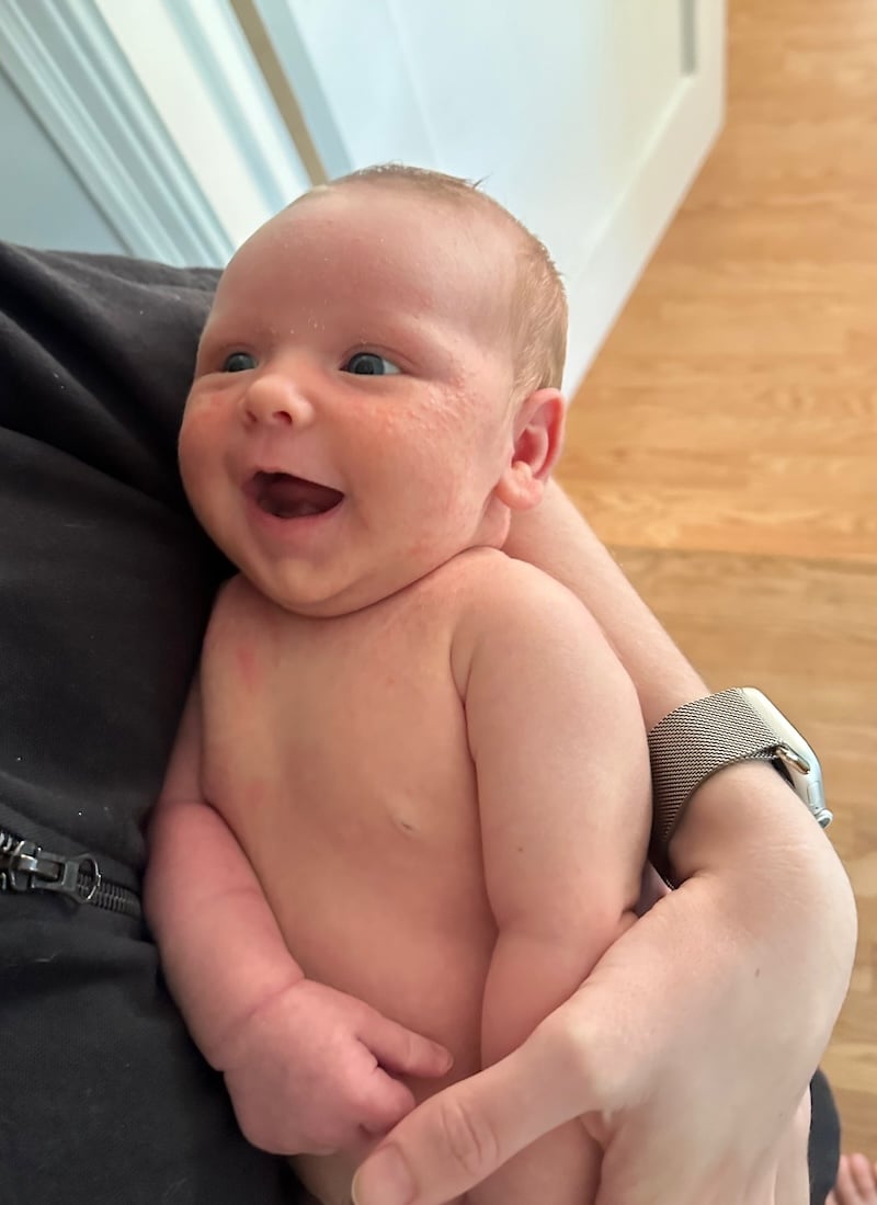 Rory being held and smiling