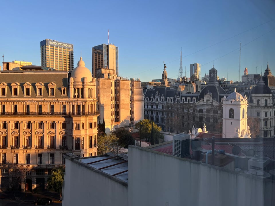 Downtown Buenos Aires scene of buildings in early morning. Some buildings are bathed in early morning golden hour light.
