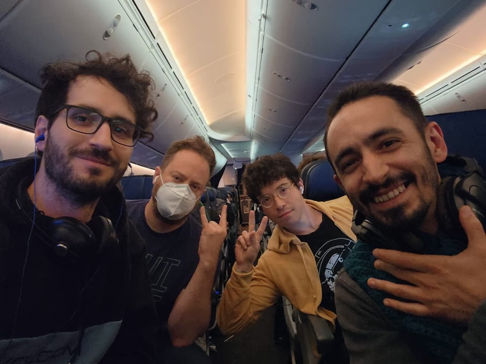 Our four-person core dev team posing on a plane