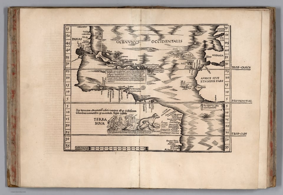 An old book is open to a map showing the Atlantic Ocean as it was conceived in the sixteenth century