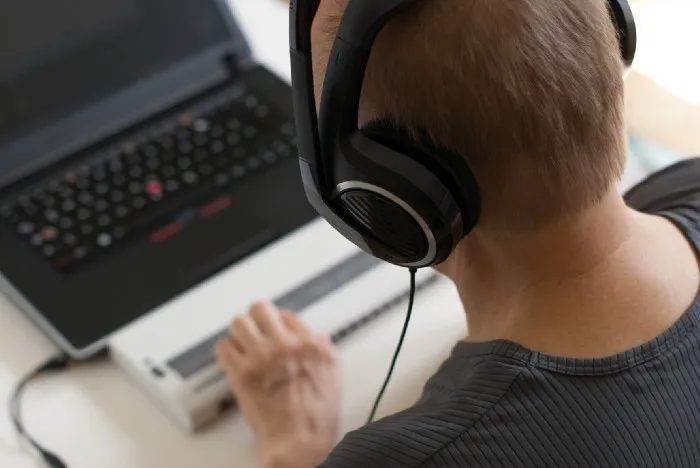 a man with headphones and a laptop