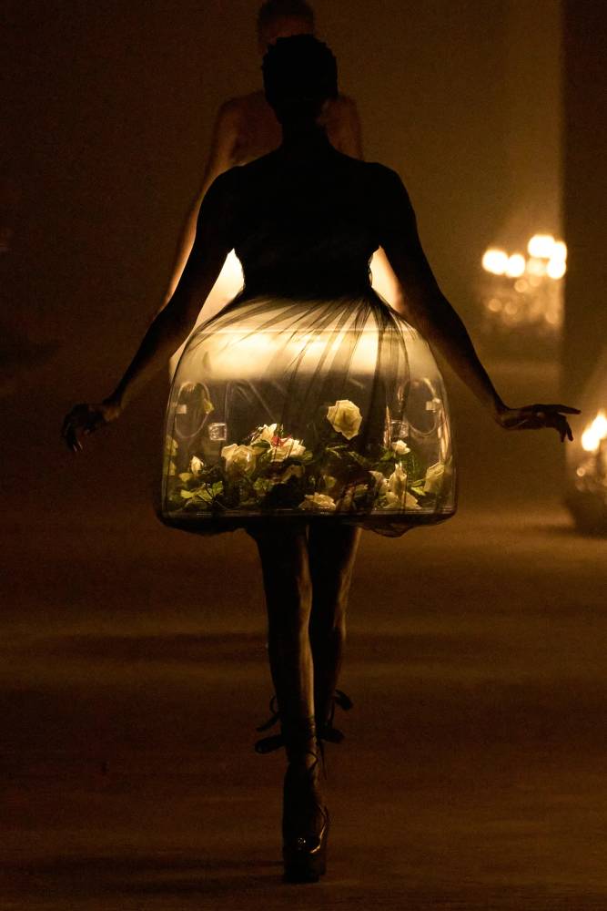 A model wears a dress that has a terrarium in its skirt. A photo by Daniele Oberrauch of Gorunway.com from Undercover's Spring 2024 fashion show.