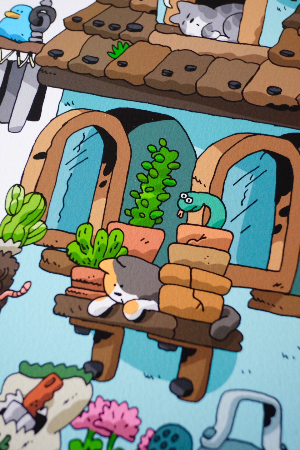 detail of the previous image. A cat and a snake are watching a woman repot a cactus.