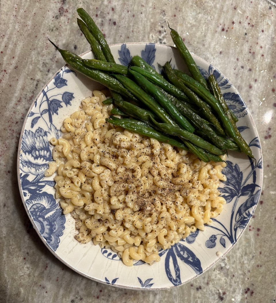 Macaroni in a cheese and pepper sauce (cacio e pepe) with haricots verts on the side.