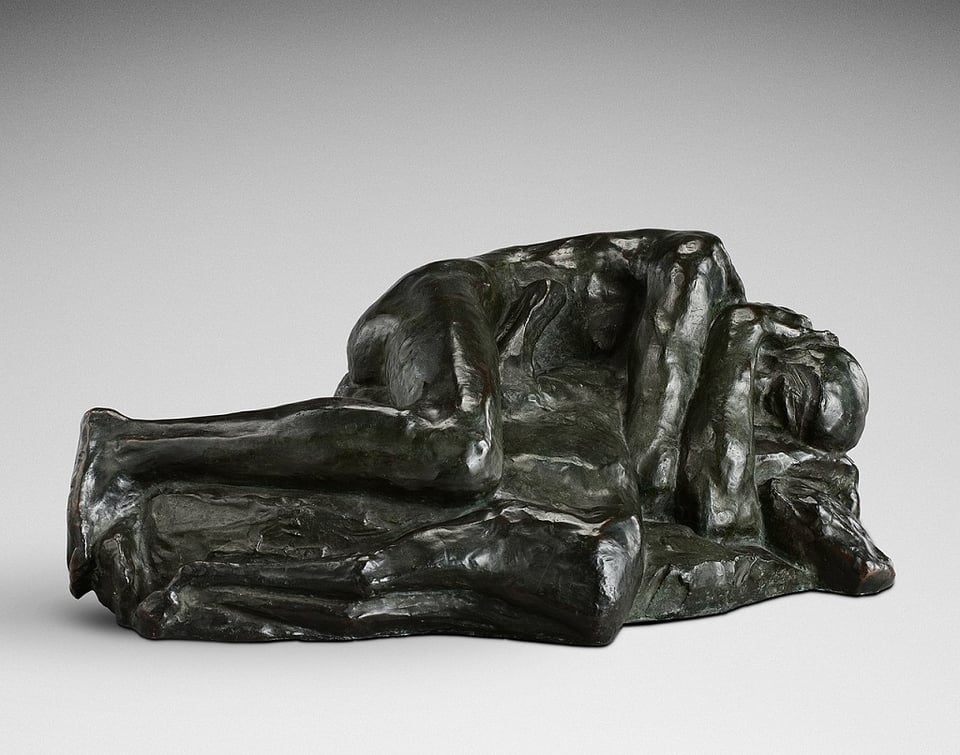 A bronze sculpture called “Man grieving over a Dead Deer”, it shows someone laying down with their arms wrapped around a mass in grief. The mass doesn’t appear to have as much detail as the man.