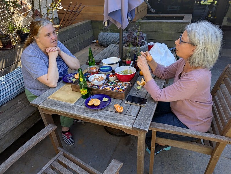 v and karen at a patio table having lunch in the garden
