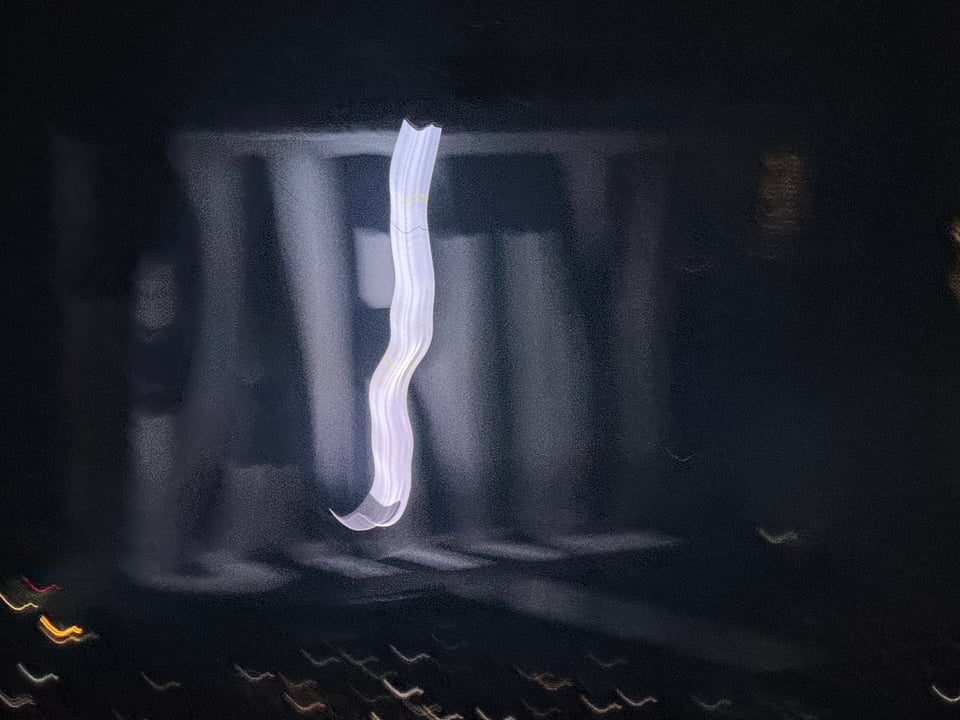 A giant banner that says 'party' with a swinging rope of light in front of it. The exposure is long A giant banner that says 'party' with a swinging rope of light in front of it. The exposure is long