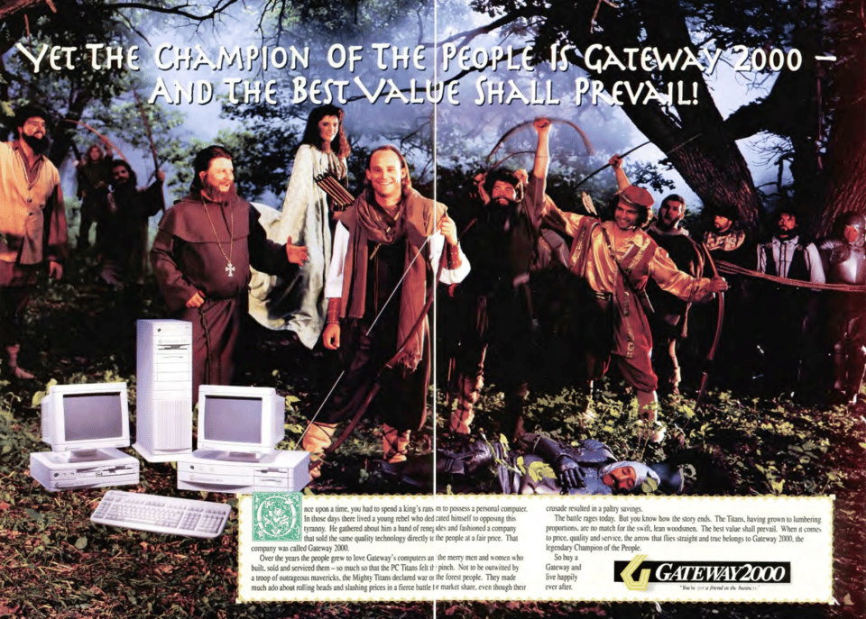 A two-page magazine advertisement that shows a large group of people standing in a forest surrounding Ted Waitt dressed as Robin Hood. The headline reads "Yet the Champion of the People is Gateway 2000"