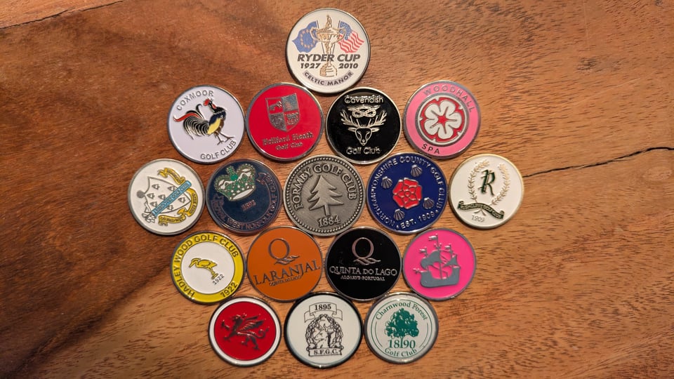 A collection of 17 ball markers from clubs played in 2024