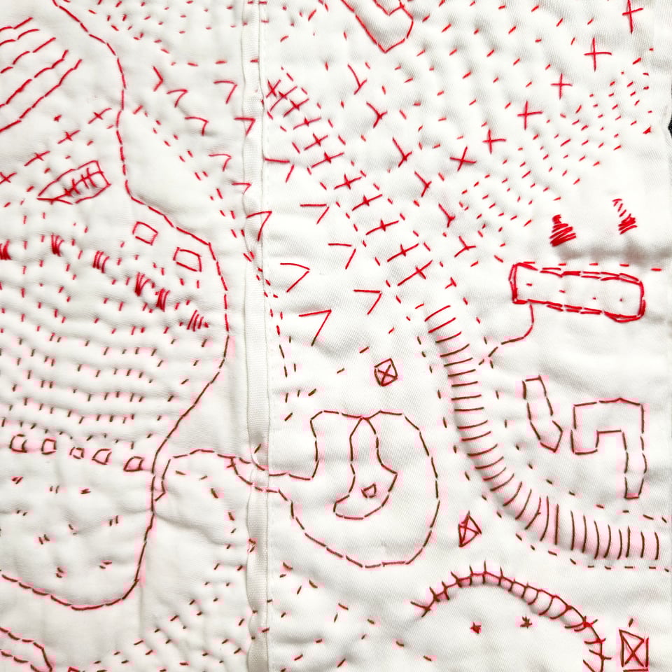 Detail of Red Map, a hand stitched quilt by Sarah Atlee. Red thread on white pillowcase, 2025.