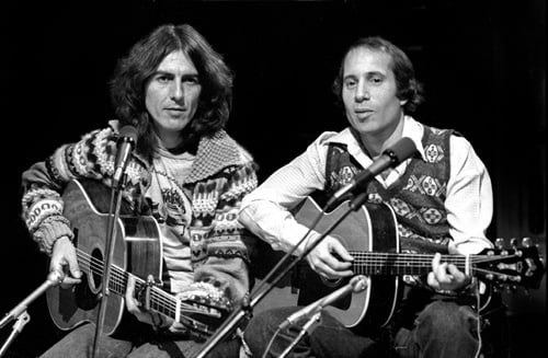 two men playing acoustic guitars