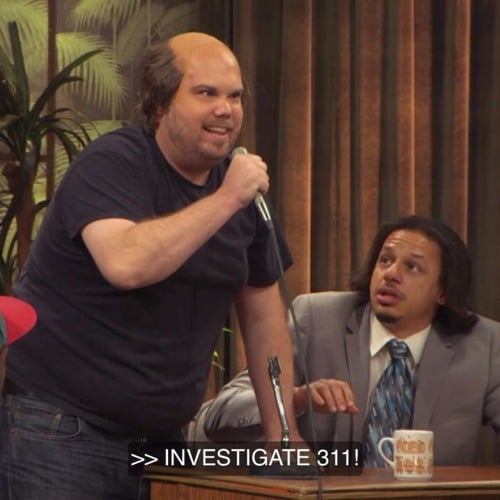 A man yelling 'Investigate 311!' while Eric Andre looks on with an uncharacteristic level of concern.