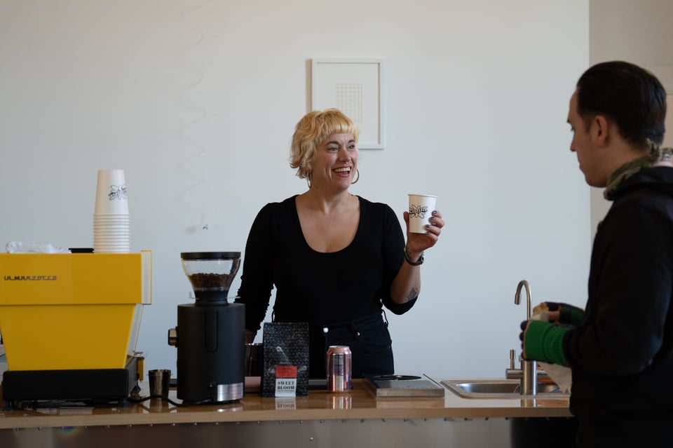 Beth possibly pretend-serving Dan some coffee.