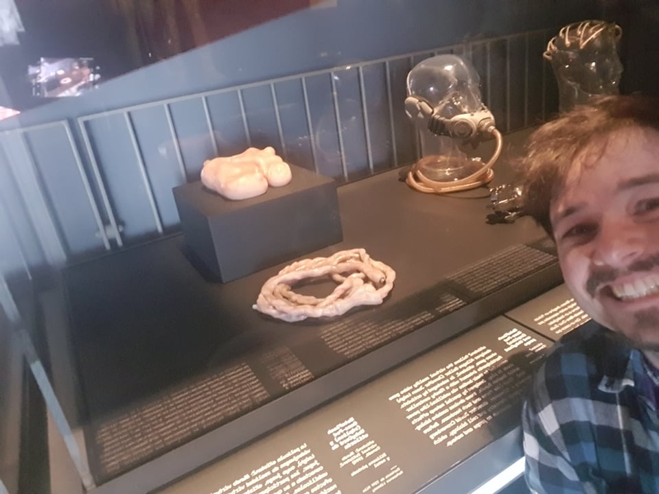 A selfie of Giles Crawford with a museum display of fake intenstines.