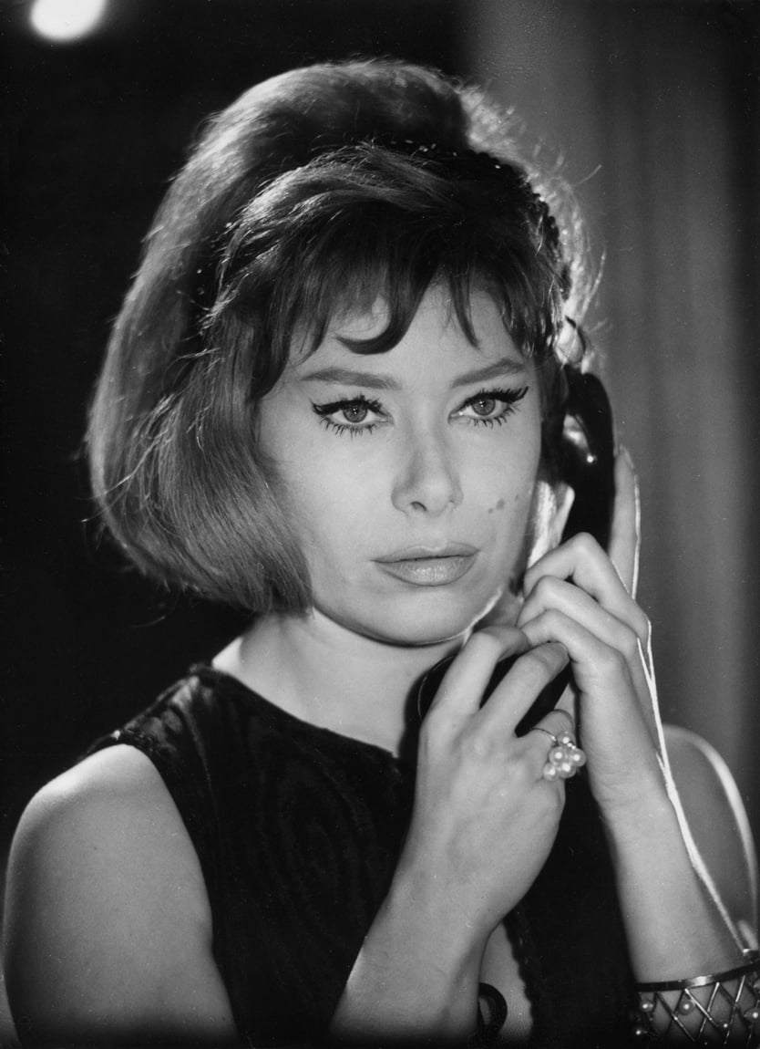 German actress Kai Fischer holding a telephone receiver.