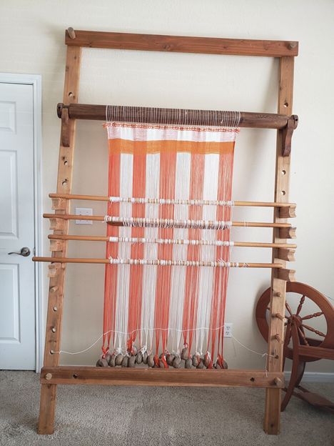 Upright loom with weaving in progress