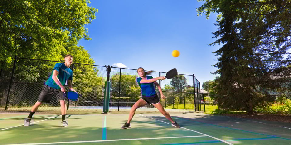 A couple playing pickleball.