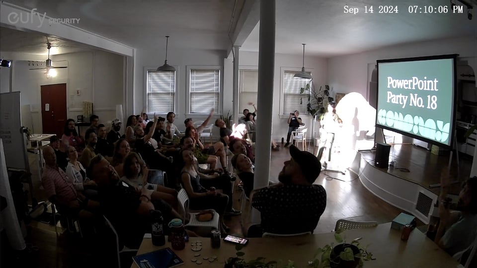 People waving at a security camera.