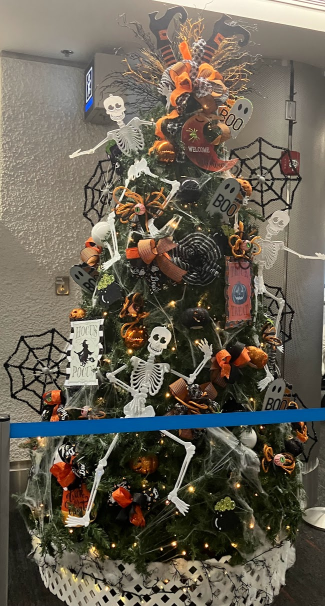 Christmas tree in the Miami airport decorated with skeletons, spiders, and cobwebs for Halloween.