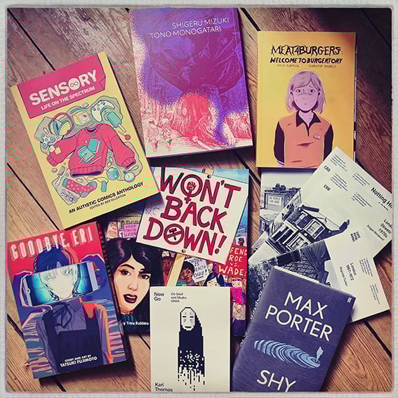 Photo of the listed books in one of Lucy's current reading piles