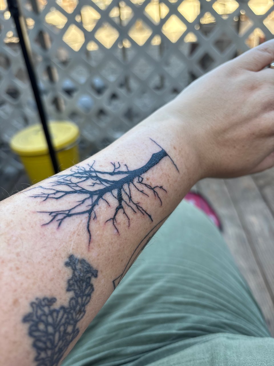 tattoo of a tree on my lower arm above the back of my wrist.