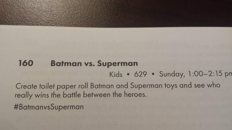 A page from a sci-fi convention program advertising a kids session called "Batman vs Superman" in which kids can make Superman and Batman out of toilet paper rolls to see who wins the battle between them