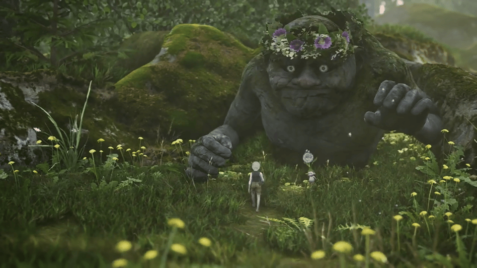 A large, moss-covered troll with a floral crown looms over two small figures walking along a path in a lush, grassy forest.