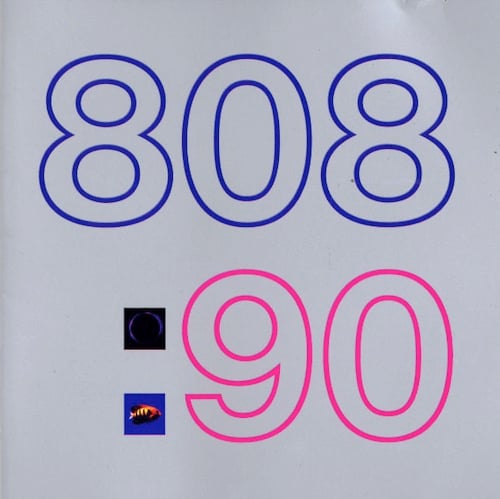 The album has a grey background. On the top in large lettering is "808" in dark blue/purple. On the bottom is ": 90." The 90 is in dark pink. The two boxes of the : have pictures in them. The lower one shows a photo of an orange fish on a blue background. The top box is difficult to make out. It looks like a purple ring on a black background, perhaps a photo of an eclipse.