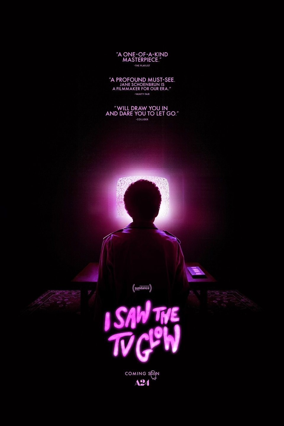 Movie poster for I Saw the TV Glow, depicting a backlit Owen sitting in front of a glowing pinkish-purple tv screen, with the movie title in glowing pinkish-purple letters below