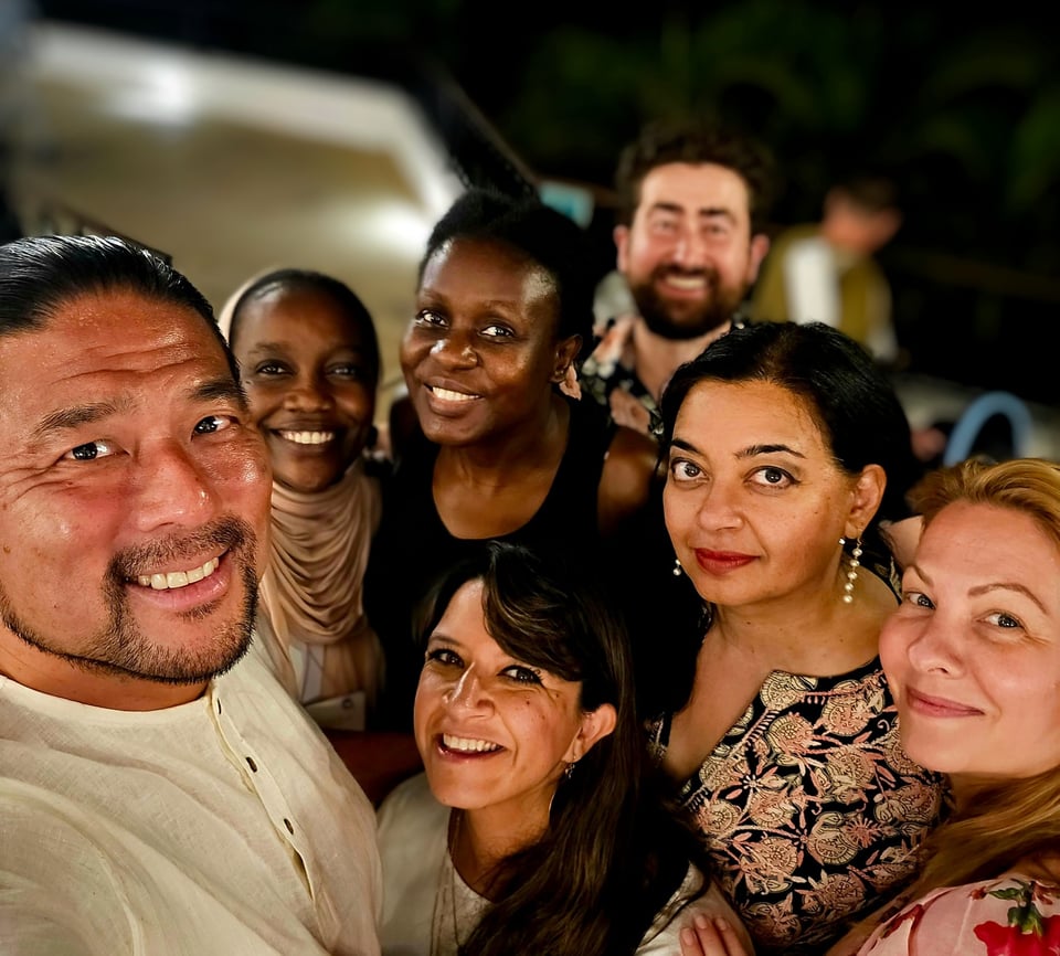 Photo of a group of people at standing together in joy and community at the Opportunity Collaboration