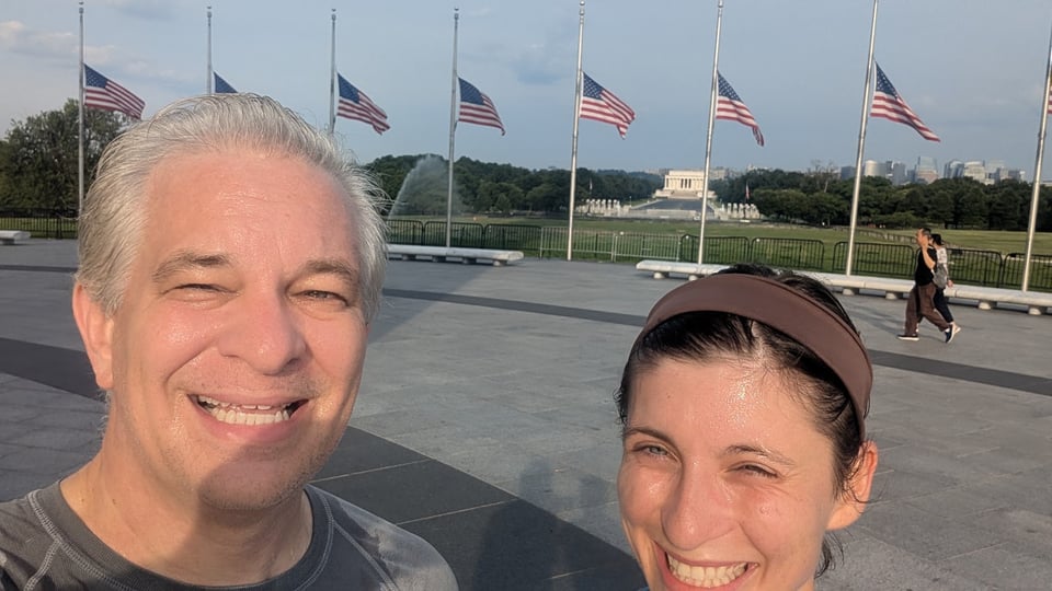 Karl's overly sweaty image at the mid-point of his run with his daughter, Lincoln memorial and flags at half-staff in the background.
