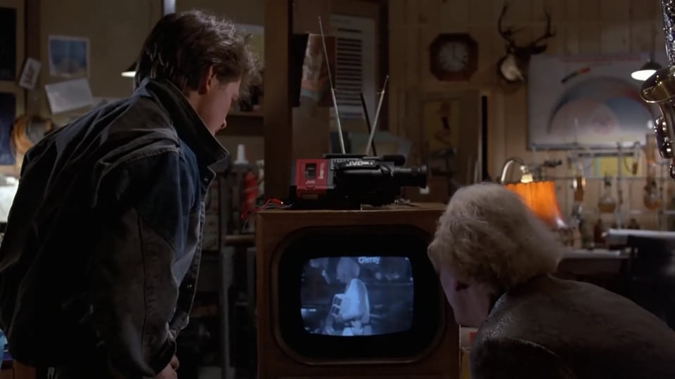 In 1955, Doc and Marty look at a video recording from 1985, with Marty's camcorder plugged into Doc's old TV set