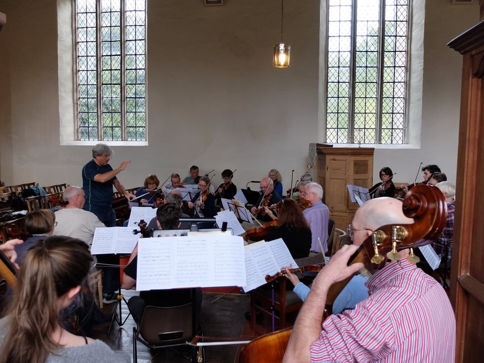 An orchestra in a brightly lit church.
