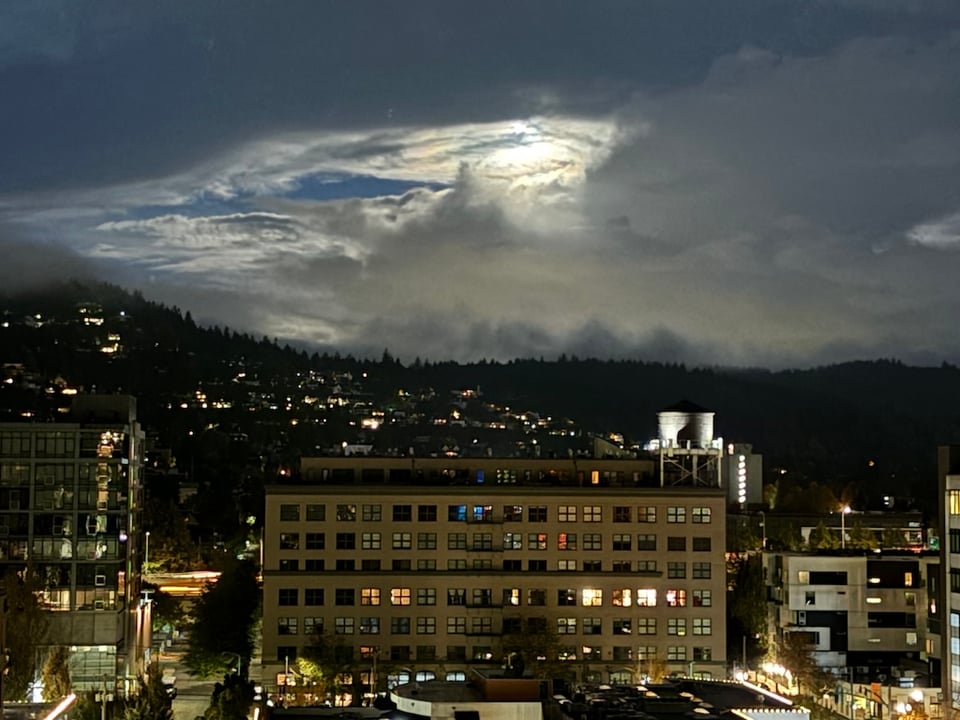 Harvest moon, obscured by clouds, looking west