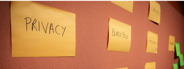 Large orange post it notes on a red wall, that read Privacy and Black Box.
