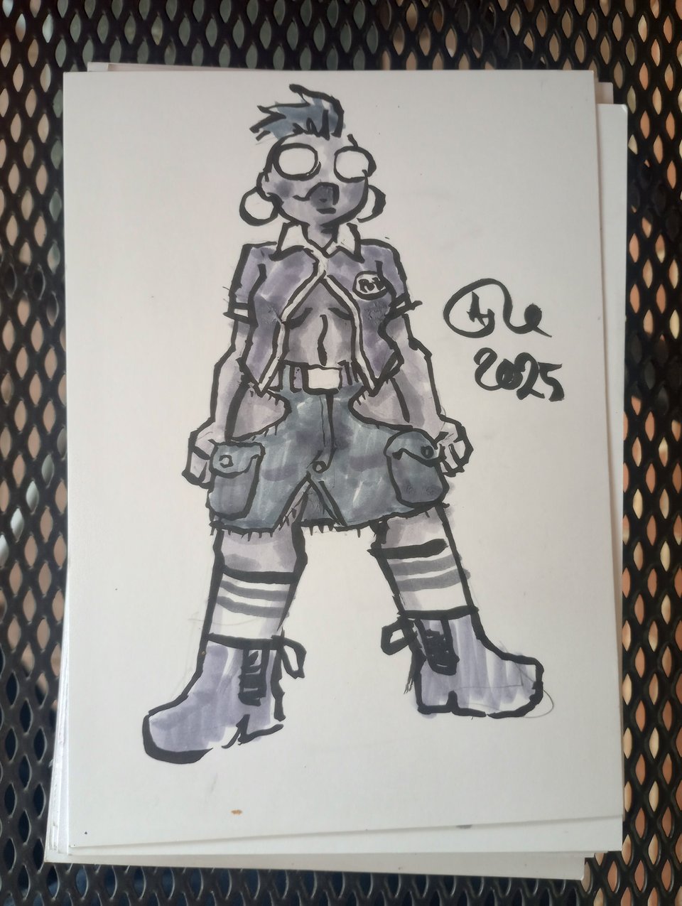 Val in a bowling shirt, ankle boots, tube socks, and cargo pants that have been cut and sewn into a skirt with hip windows above the big ol pockets