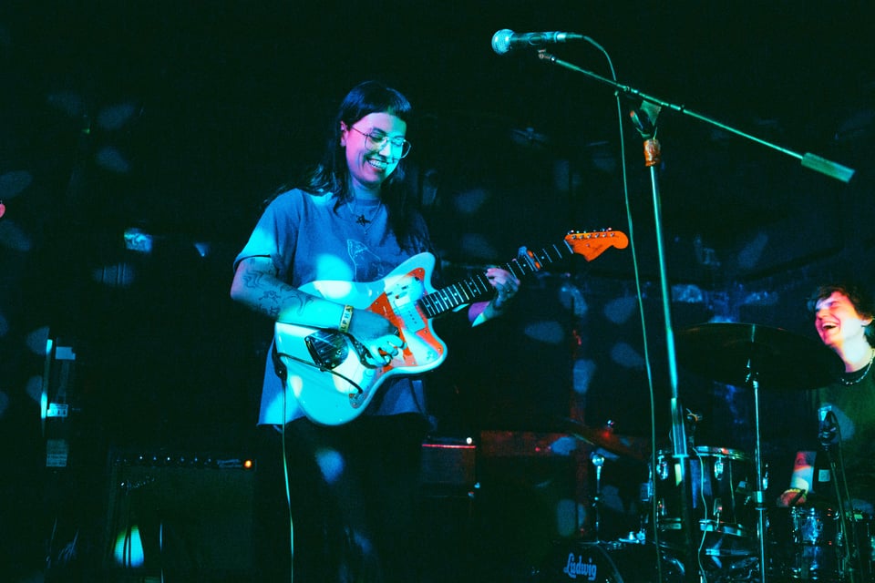 Claire and Izzy laughing after a song
