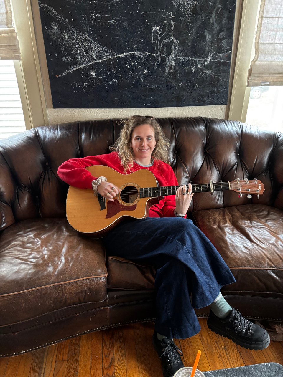 a woman playing an acoustic guitar