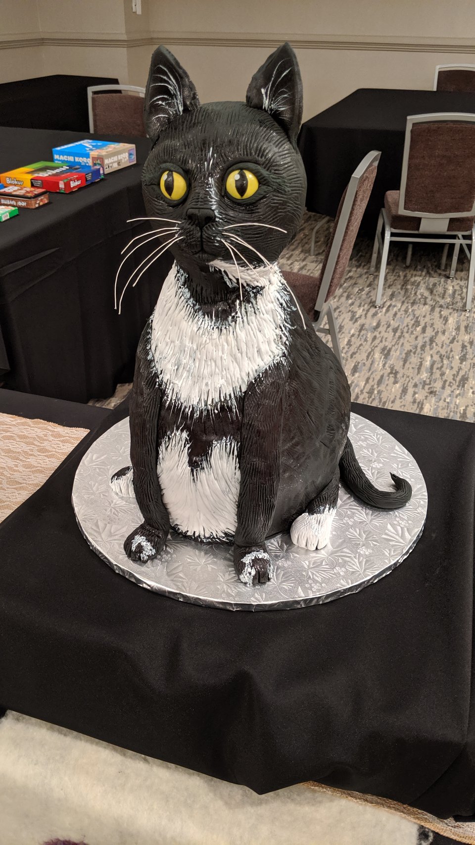A cake made in the shape of a tuxedo cat
