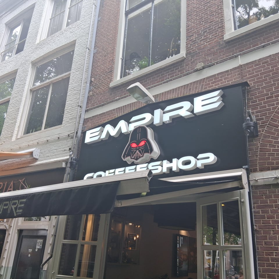 A shop with a logo that looks like Darth Vader. It claims to be a coffee shop.